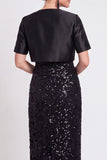 Abito lungo con paillettes nere scintillanti con fessura